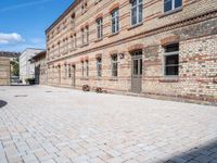 there is a bike leaning against the wall of some brick buildings and patios and a building with two buildings