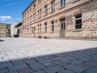 there is a bike leaning against the wall of some brick buildings and patios and a building with two buildings