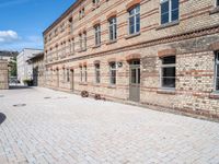 there is a bike leaning against the wall of some brick buildings and patios and a building with two buildings