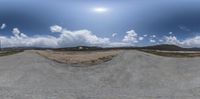 view from the top of a street looking up into a cloudy sky and the ground