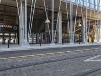 the entrance of an orange park station building with columns on either side and a street below