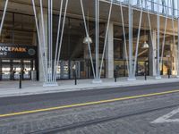 the entrance of an orange park station building with columns on either side and a street below