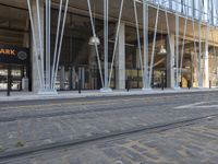 the entrance of an orange park station building with columns on either side and a street below