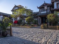 an oriental style home with its entrance covered in snow next to the walkway and fence