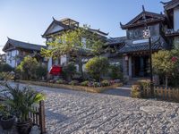 an oriental style home with its entrance covered in snow next to the walkway and fence