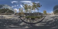 the 360 - view image shows buildings and trees in an empty road outside of a business center