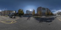 a fish - eye lens photo of a parking lot with buildings in the background with cars