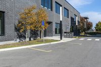 a stop sign is in front of a brick building on a street corner with yellow lines painted on