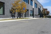 a stop sign is in front of a brick building on a street corner with yellow lines painted on