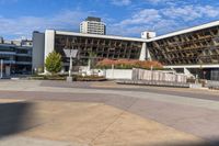 an empty plaza surrounded by tall buildings on a sunny day with the sky in the background