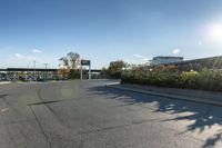 the city street has parking spaces on both sides of the road and cars parked along it