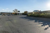 the city street has parking spaces on both sides of the road and cars parked along it