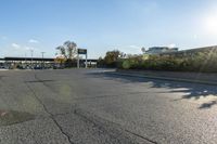 the city street has parking spaces on both sides of the road and cars parked along it