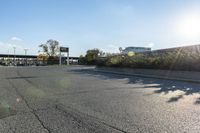 the city street has parking spaces on both sides of the road and cars parked along it