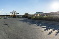 the city street has parking spaces on both sides of the road and cars parked along it