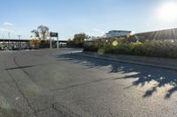 the city street has parking spaces on both sides of the road and cars parked along it