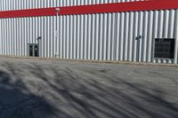 a red, gray and white building in a parking lot next to a fire hydrant