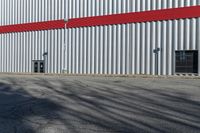 a red, gray and white building in a parking lot next to a fire hydrant