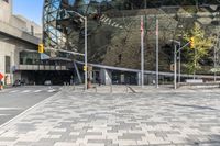 there is a brick square in front of a building with a large dome on top