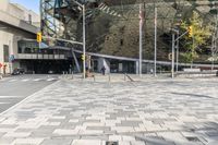 there is a brick square in front of a building with a large dome on top