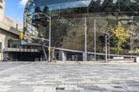 there is a brick square in front of a building with a large dome on top