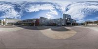 a 360 view of an urban area at the bottom of a hill with buildings and other building in the background