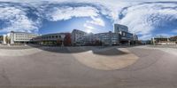 a 360 view of an urban area at the bottom of a hill with buildings and other building in the background