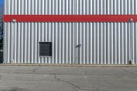 the building is red and white with stripes on it's side and black windows