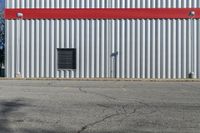 the building is red and white with stripes on it's side and black windows