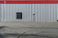 the building is red and white with stripes on it's side and black windows