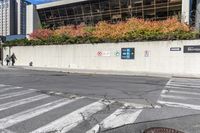 a picture of a building near a parking lot in the day time next to a crosswalk