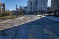 a city street that is empty and has no people or cars in it and has buildings on either side