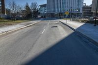 a city street that is empty and has no people or cars in it and has buildings on either side