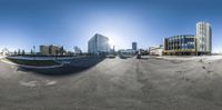 some buildings and some cars at the intersection of a road and a person standing in front of a mirror