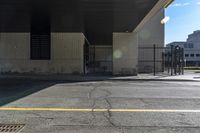 there is an empty parking lot outside of the building as well as trees and buildings