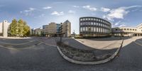 there are many buildings and the road is empty yet taken out in this image in spherical format