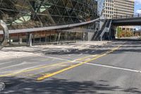 a very long building that is on some sort of road somewhere in the city of vancouver