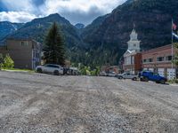 a big house with two fire trucks parked next to it and mountains in the background