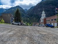 a big house with two fire trucks parked next to it and mountains in the background