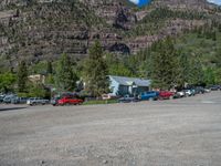 a big house with two fire trucks parked next to it and mountains in the background