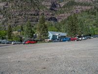 a big house with two fire trucks parked next to it and mountains in the background