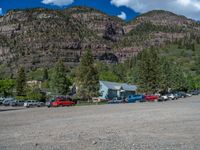 a big house with two fire trucks parked next to it and mountains in the background