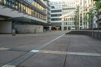 a person sitting on a bench in front of a building with stairs going up to it