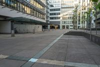 a person sitting on a bench in front of a building with stairs going up to it