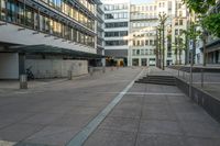 a person sitting on a bench in front of a building with stairs going up to it