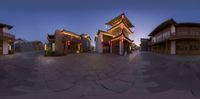 a fisheye lens is shown of the view on an outdoor market square, showing a cityscape, including traditional building buildings and shops