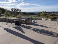 the patio has tables and chairs set out to enjoy the outdoors sun and views of the mountains