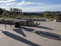 the patio has tables and chairs set out to enjoy the outdoors sun and views of the mountains