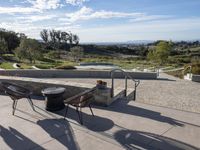 the patio has tables and chairs set out to enjoy the outdoors sun and views of the mountains