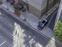 an overhead view shows the parking meters on a busy city street in a shadow - cast image